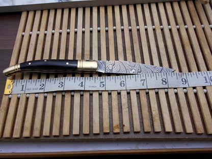 Laguiole Folding Damascus steel knife, 8.6" Long with 4.1" hand forged custom twist patren Blade. Wine 2 Tone Dollar wood & brass bolster scale. Cow hide leather sheath included (Bull Horn)